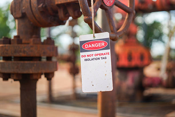 istock Isolation tag or lockout tagout which is hanged on pipeline valve. 2223677805