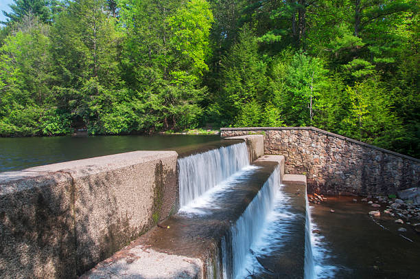 Water flowing over stone blocks at Hickory Run Lake on a sunny day in carbon county pennsylvania.