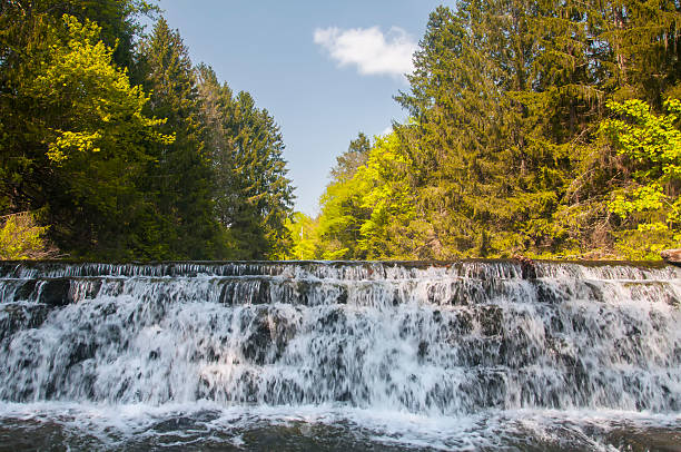 Water flowing over stone blocks on a sunny day in carbon county pennsylvania.