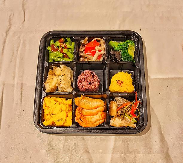 istock Bento-style meal arranged in a nine-compartment tray 2223680639