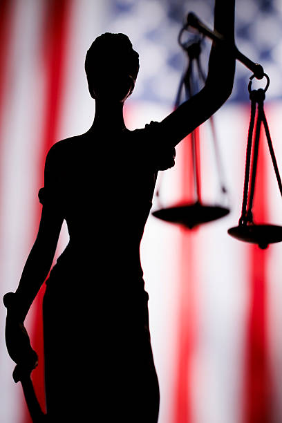 Lady justice silhouette in front of American flag