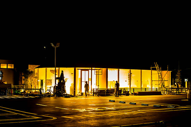 Aerial view of an empty retail centre parking lot at night.