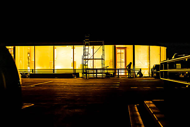 construction site at night where finishing work is being carried out on the store before it opens.
