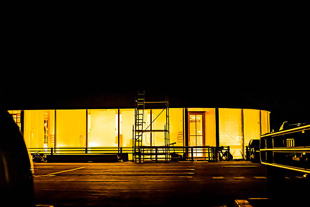 construction site at night where finishing work is being carried out on the store before it opens.