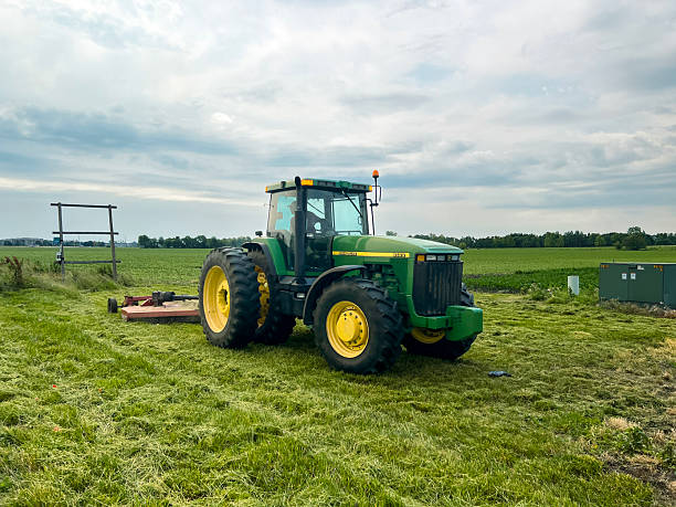 a man on a commercial lawn mower takes cuts grass