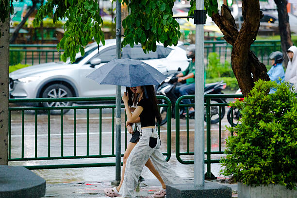 Palermo, Sicily, Italy Jan 12, 2024 A young happy couple kissing  under an umbrella in the rain.