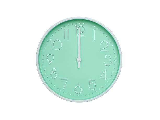 istock Modern mint green wall clock with white frame and numbers, showing 12:00 PM or 12:00. Ideal for minimalist designs, time-related content, or morning routine visuals. 2223689217