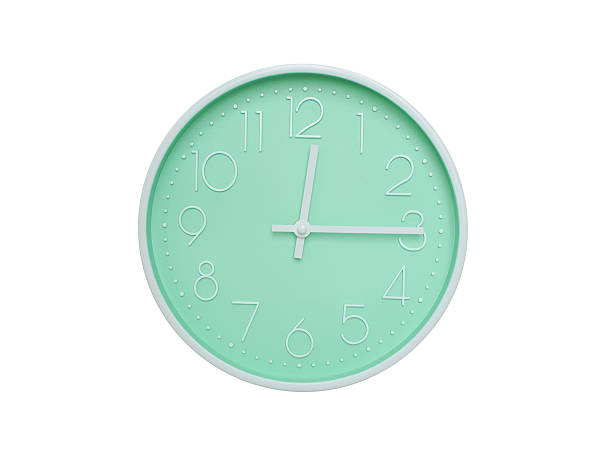 istock Modern mint green wall clock with white frame and numbers, showing 12:15 PM or 12:15. Ideal for minimalist designs, time-related content, or morning routine visuals. 2223689223