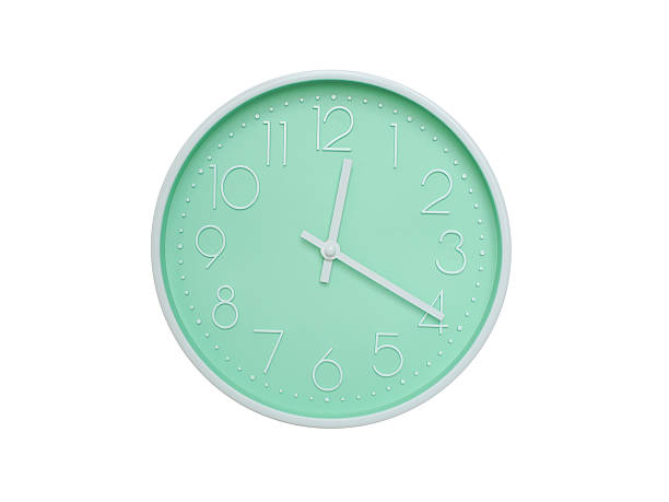 istock Modern mint green wall clock with white frame and numbers, showing 12:20 PM or 12:20. Ideal for minimalist designs, time-related content, or morning routine visuals. 2223689236