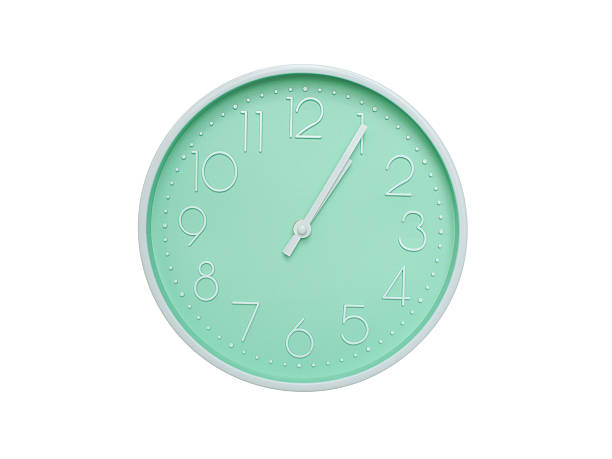 Modern mint green wall clock with white frame and numbers, showing 01:05 AM or 01:05. Ideal for minimalist designs, time-related content, or morning routine visuals.