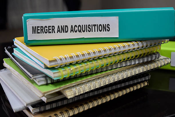 istock Folders with the label merger and acquisitions. Business management concept 2223689309