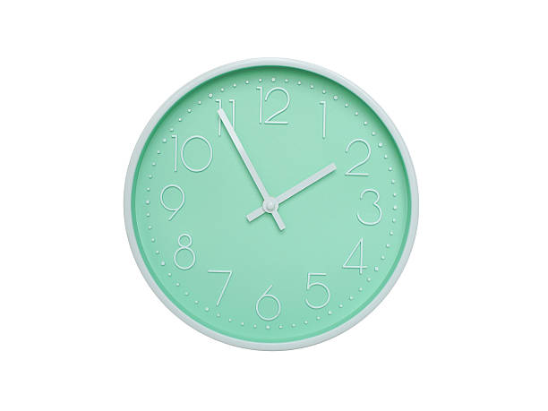 Modern mint green wall clock with white frame and numbers, showing 01:55 AM or 01:55. Ideal for minimalist designs, time-related content, or morning routine visuals.