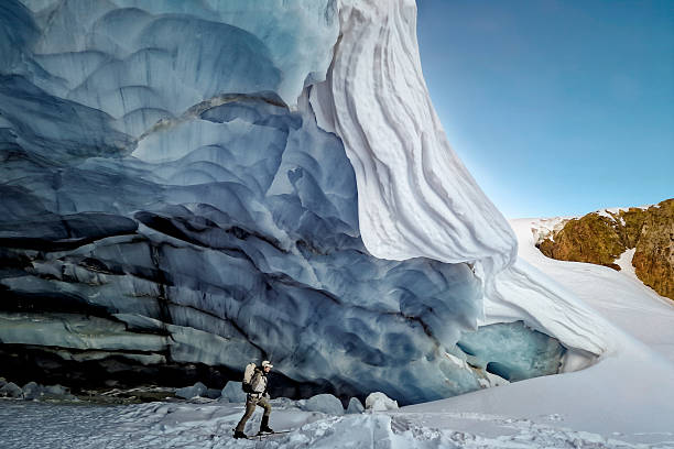 Ski mountaineer climbs below giant crevasse