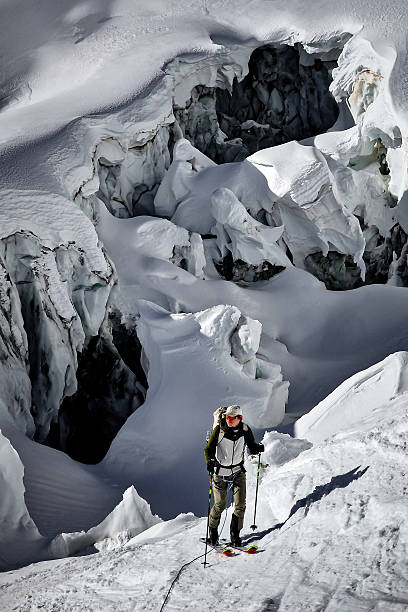 A view of a ridge of jagged, high, snow-covered mountains in the French Alps. Photo taken from the Aiguille du Midi mountain. Chamonix. large snow cover with footprints is visible