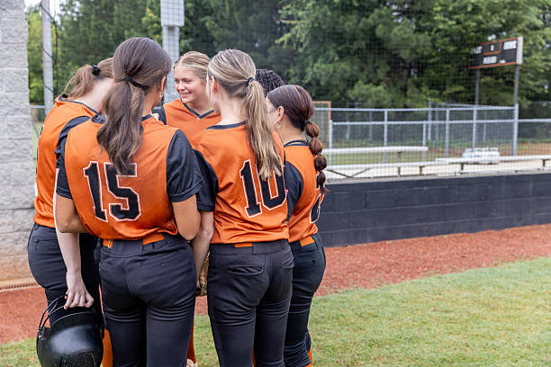 istock Softball players are huddles discussing play before taking the field during high school game 2223694697