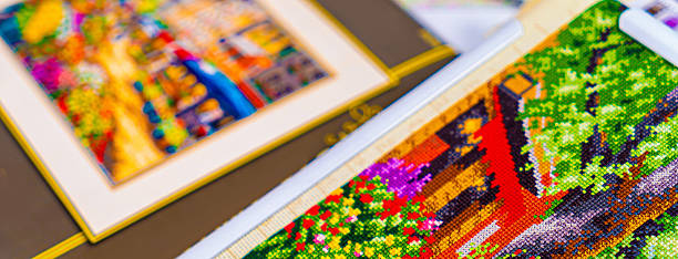 Close up of a cross stitch embroidery with colorful flowers