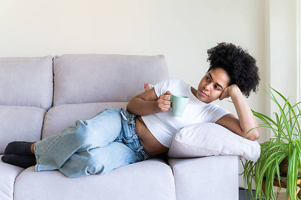 istock Woman relaxing on sofa 2223696594