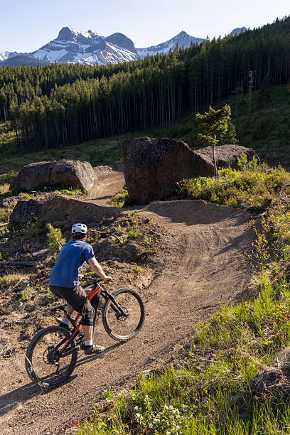 istock Young man mountain bikes along flow track 2223700929