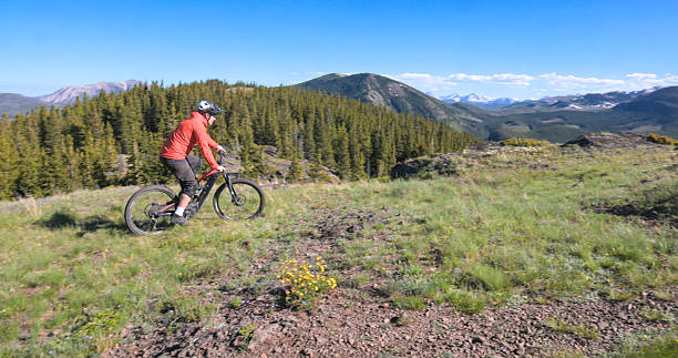 istock Young man mountain bikes trail on mountain top 2223701249