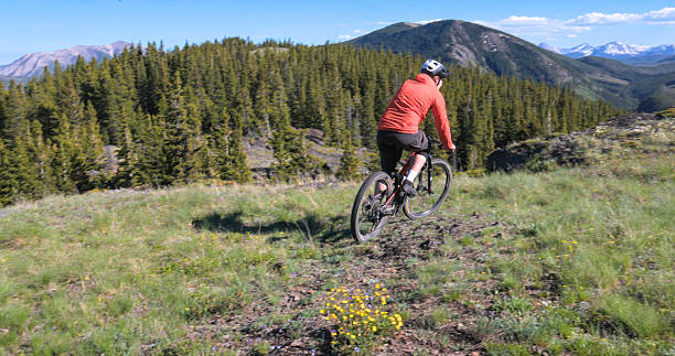 istock Young man mountain bikes trail on mountain top 2223701258