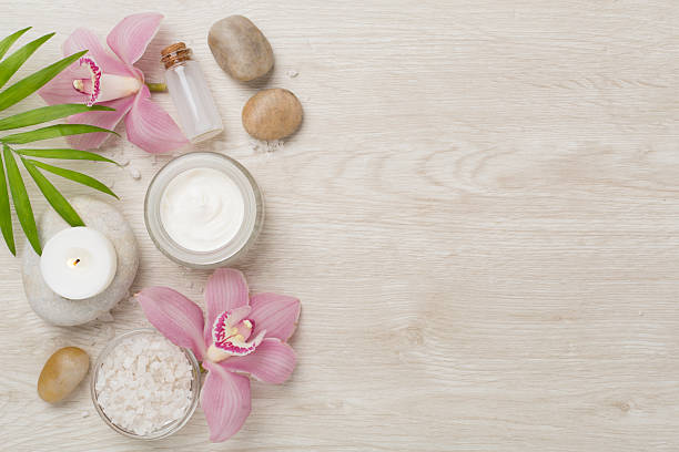 istock Composition with orchids and massage stones on wooden background, top view 2223701908