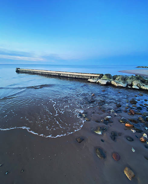 istock Wave breaker in calm sea 2223705761