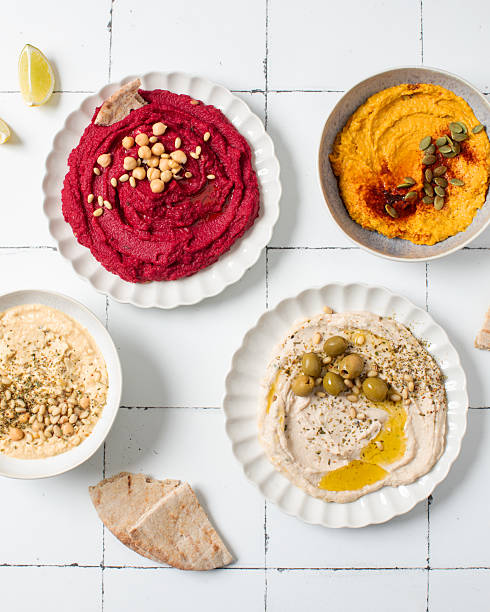 istock Different types of hummus in bowls and plates. Beetroot, pumpkin, chickpea and bean hummus. 2223710736