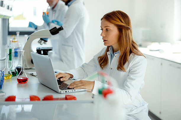 istock Woman Researcher Analyzing Data on Laptop in Lab 2223712615