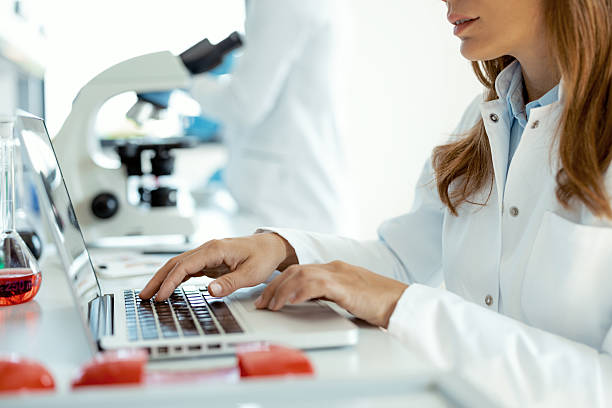 istock Woman Researcher Analyzing Data on Laptop in Lab 2223712636