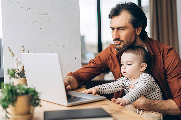 istock Loving father spending time with his newborn son while working on his laptop at home 2223713084