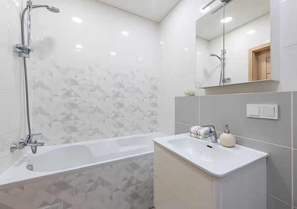 istock Modern Bathroom Interior with Bathtub, Sink, and Clean White Tiled Design 2223717117