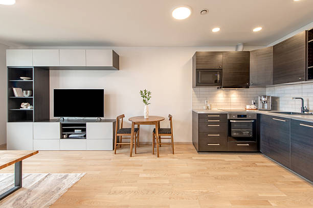 istock Modern Open Kitchen Featuring Wooden Flooring and Sleek Cabinets with Dining Area 2223717126