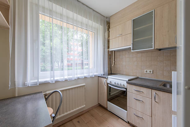 istock Small Modern Kitchen Interior with Wooden Cabinets and Natural Light 2223722314