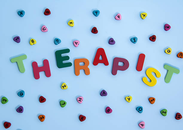 Word THERAPIST on color background. High quality photo