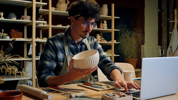 istock A man sits comfortably at a table with a bowl and laptop 2223724047