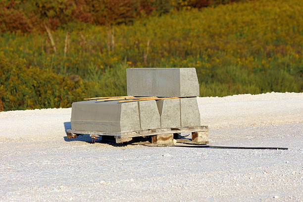 istock Concrete curbstones stacked on wooden pallet at construction site 2223730102