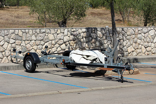 istock Empty boat trailer parked in lot by stone wall 2223730263
