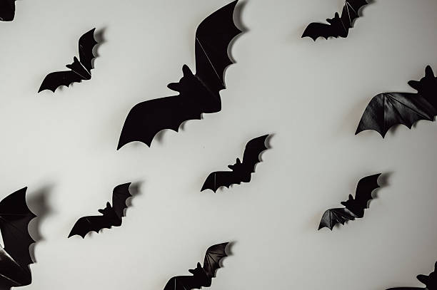 istock flying black bats for Halloween decoration. Festive background 2223733317