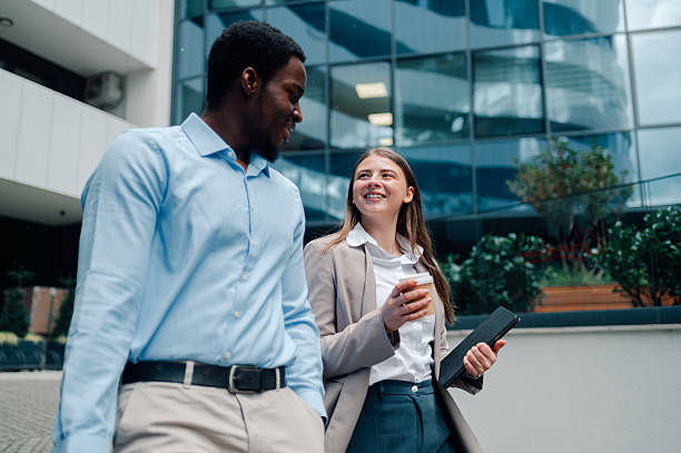 istock Business colleagues walking and talking outside office building 2223733413