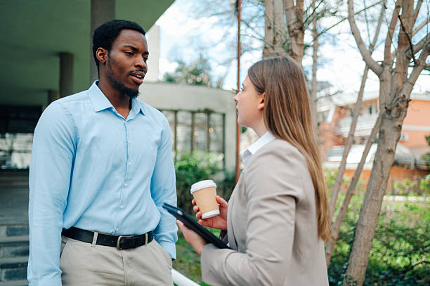 istock Business colleagues talking outside office during coffee break 2223733420
