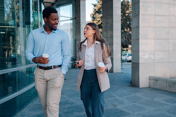 istock Business colleagues walking and talking during coffee break 2223733440
