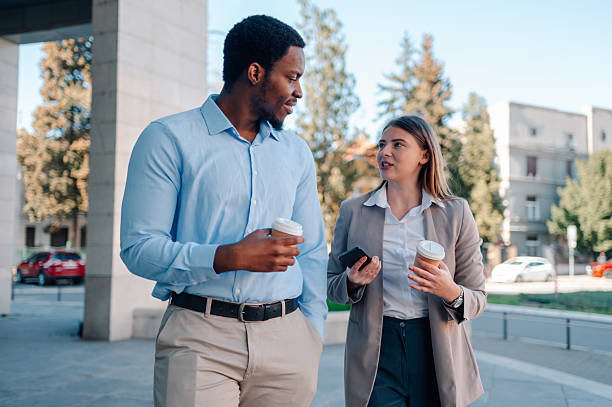 istock Business colleagues walking and talking during coffee break 2223733441