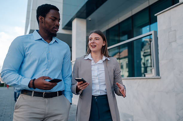istock Business colleagues walking and talking outside office building 2223733451