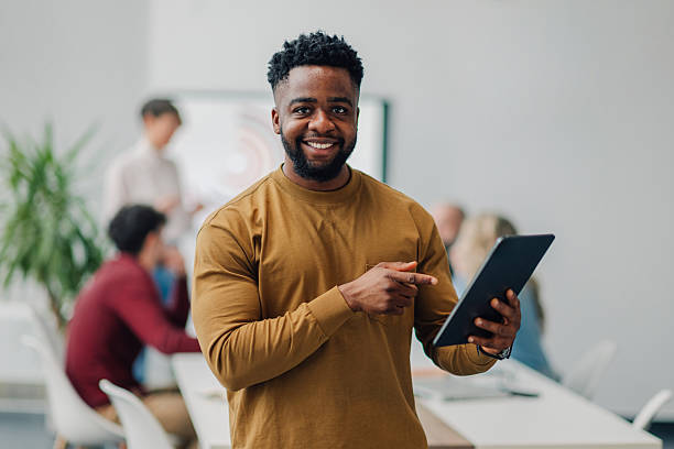 istock Young businessman showing tablet and smiling during a meeting 2223733553