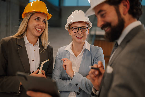 istock Engineers and architects discussing a project wearing hardhats 2223733632