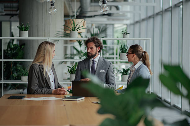 istock Businesspeople discussing work in modern green office 2223733687