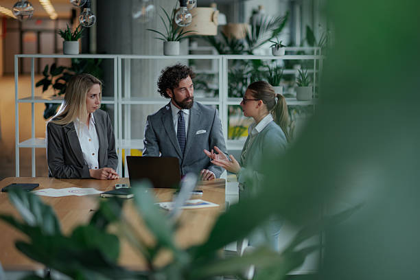 istock Businesspeople discussing work in modern green office 2223733715