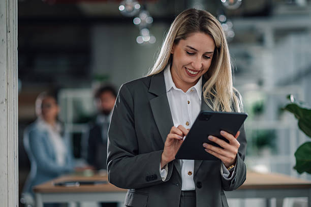 istock Smiling businesswoman using digital tablet in modern office 2223733749