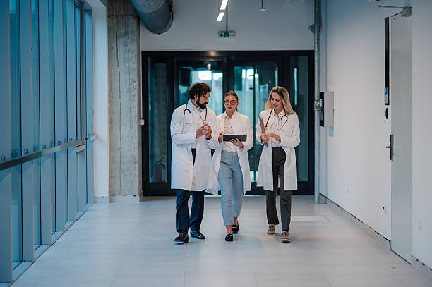 istock Doctors walking and discussing a diagnosis in hospital corridor 2223733873