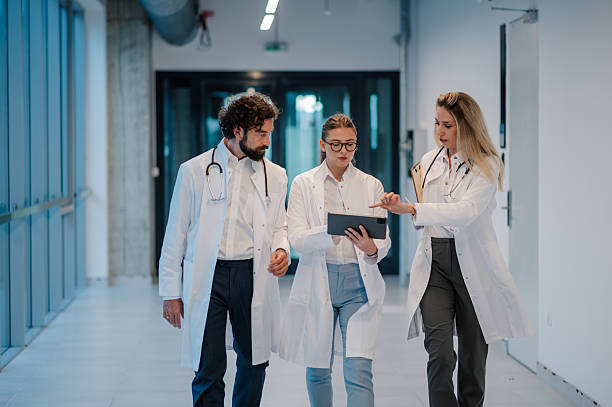 istock Doctors walking and discussing medical records on a tablet 2223733880